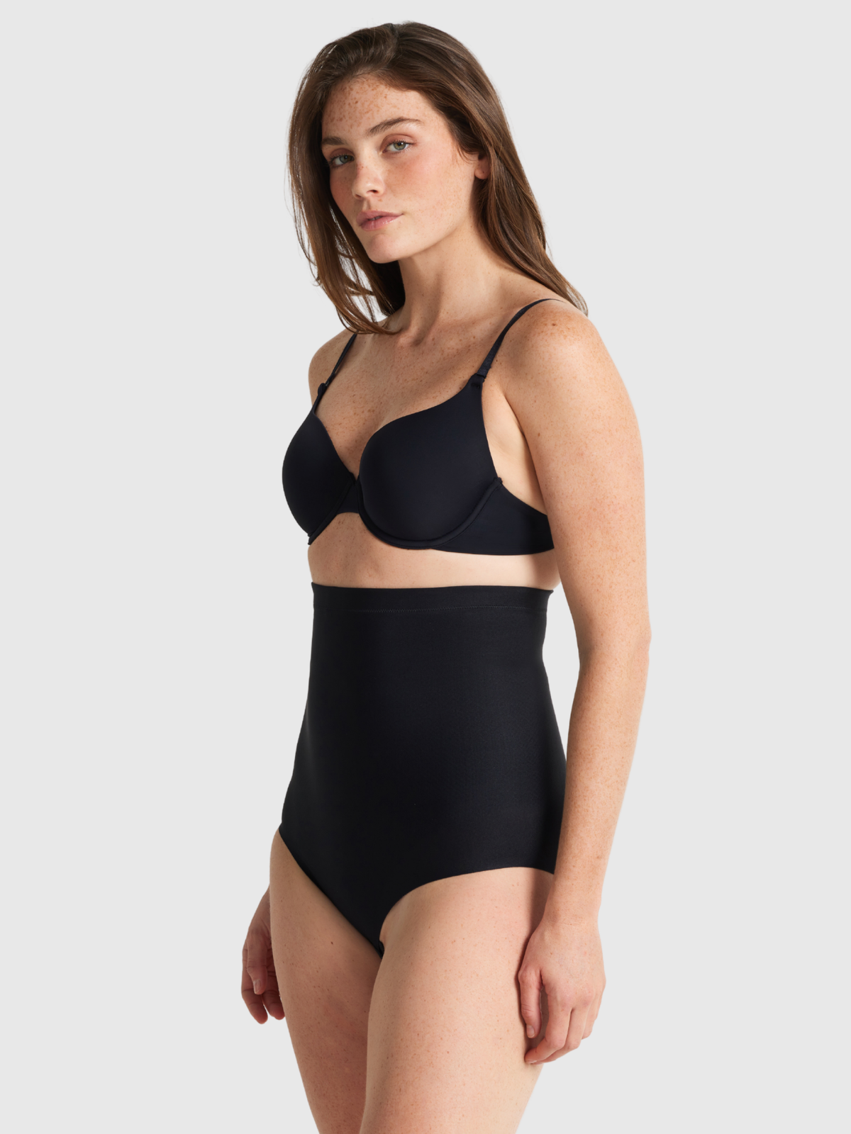 Nancy Ganz X-Factor High Waisted Brief in black, side view showing the high-rise waistband and smooth hip line.