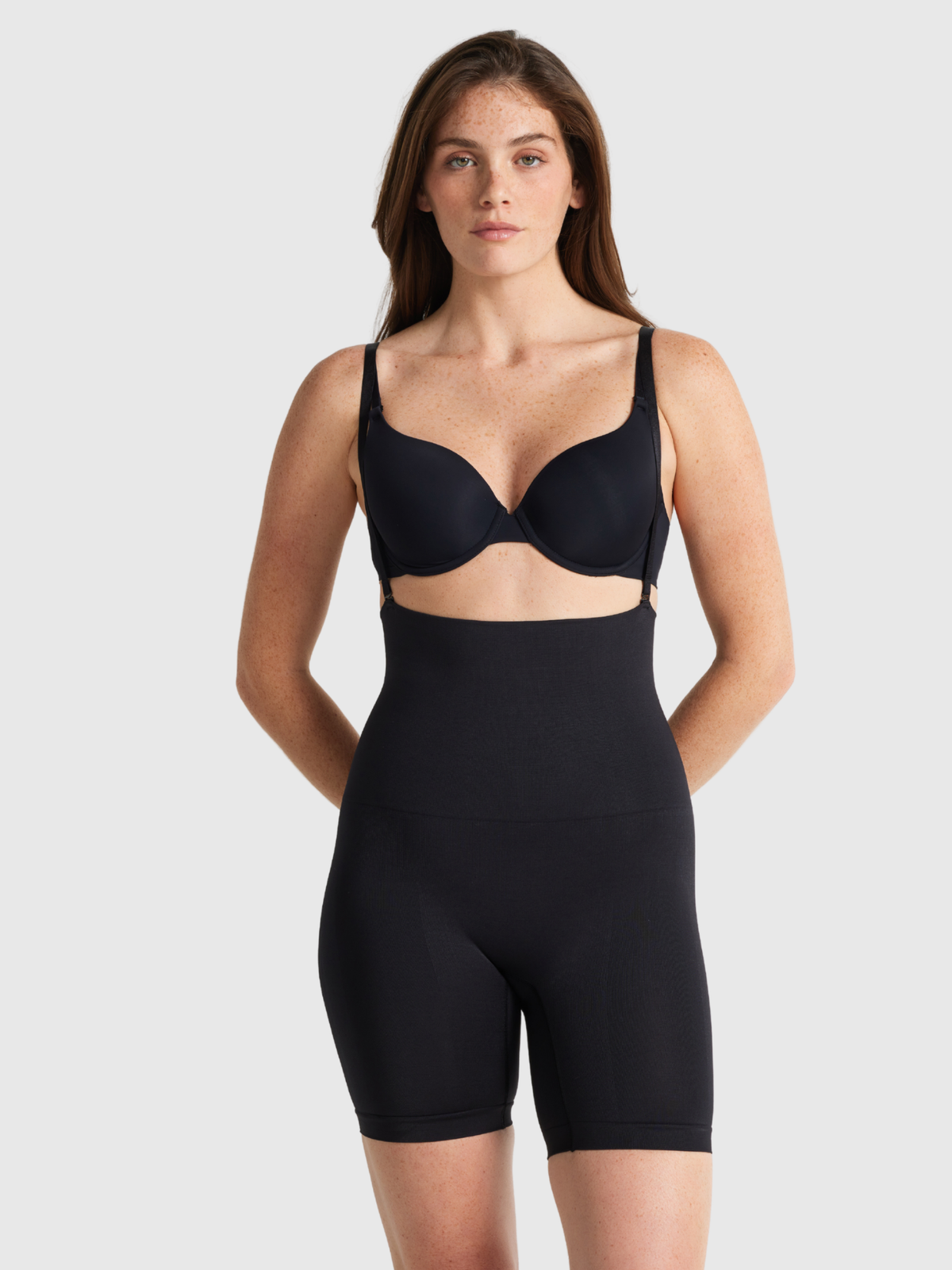 Nancy Ganz Seamless Seduction high waisted thigh shaper in Black, front view with support straps over the shoulders
