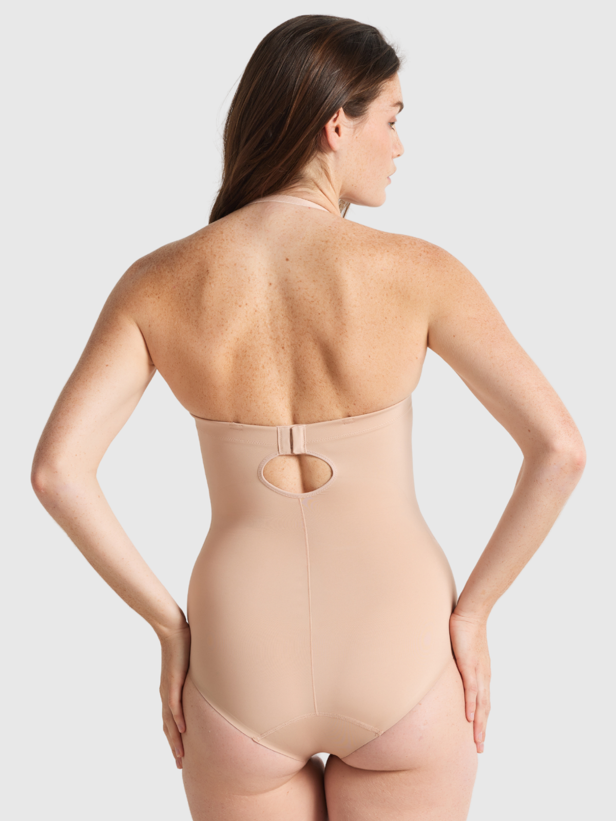 Back view of Nancy Ganz Body Define Strapless Bodysuit showing detachable straps that can be worn straight, cross-back, halter, or removed.