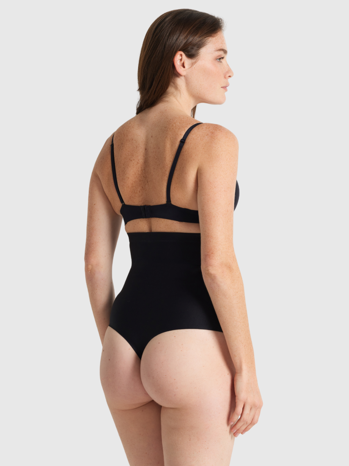 Nancy Ganz X Factor High Waisted Thong in Black – back view showing thong cut and seamless finish