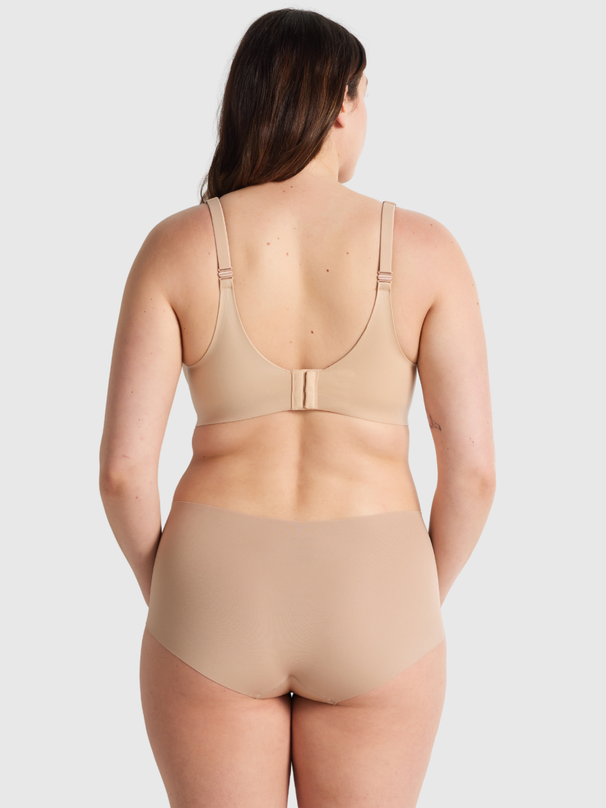 Back profile of Nancy Ganz Body Smart waisted brief shapewear featuring seamless edges and flattering smooth lines.