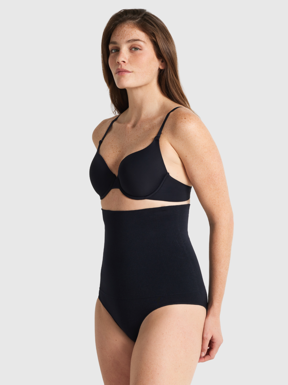 Nancy Ganz Seamless Seduction High Waisted Brief in black, side view showing high rise through the waist and a smooth hip line.