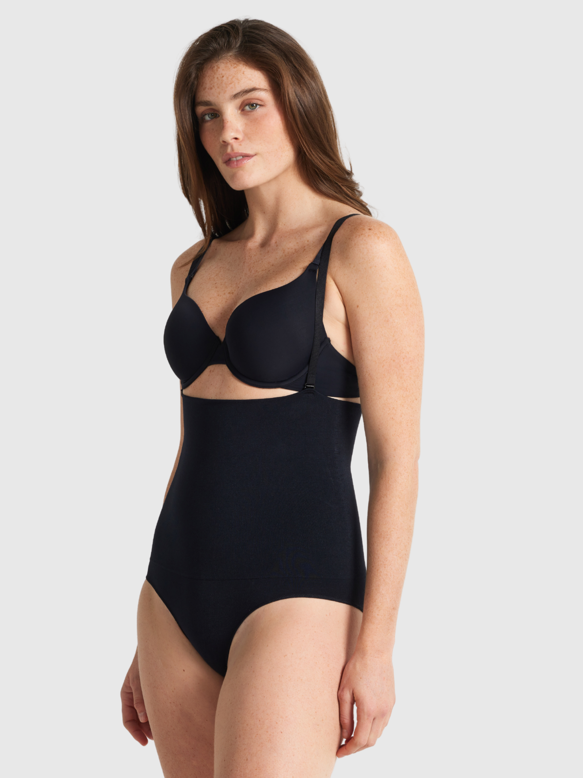Nancy Ganz Seamless Seduction High Waisted Brief in black, side view showing straps running from waistband over the shoulder, keeping the high rise in place.