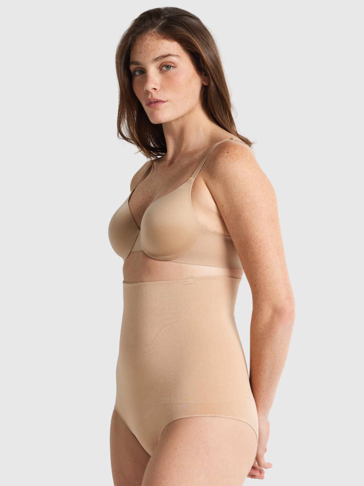 Nancy Ganz Seamless Seduction High Waisted Brief in warm taupe, side view showing high rise through the waist and a smooth hip line.