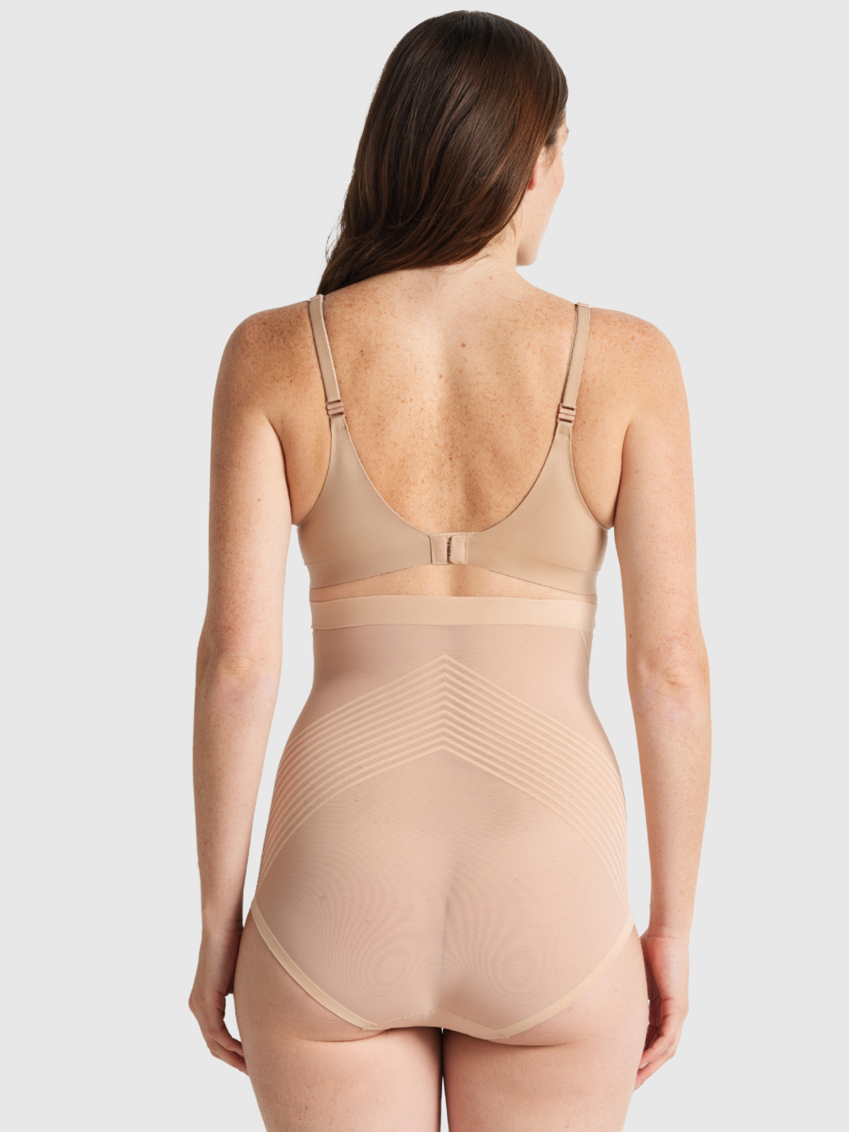 Nancy Ganz Sheer Power High Waisted Brief in warm taupe, back view showing sheer panelling across the seat and full rear coverage