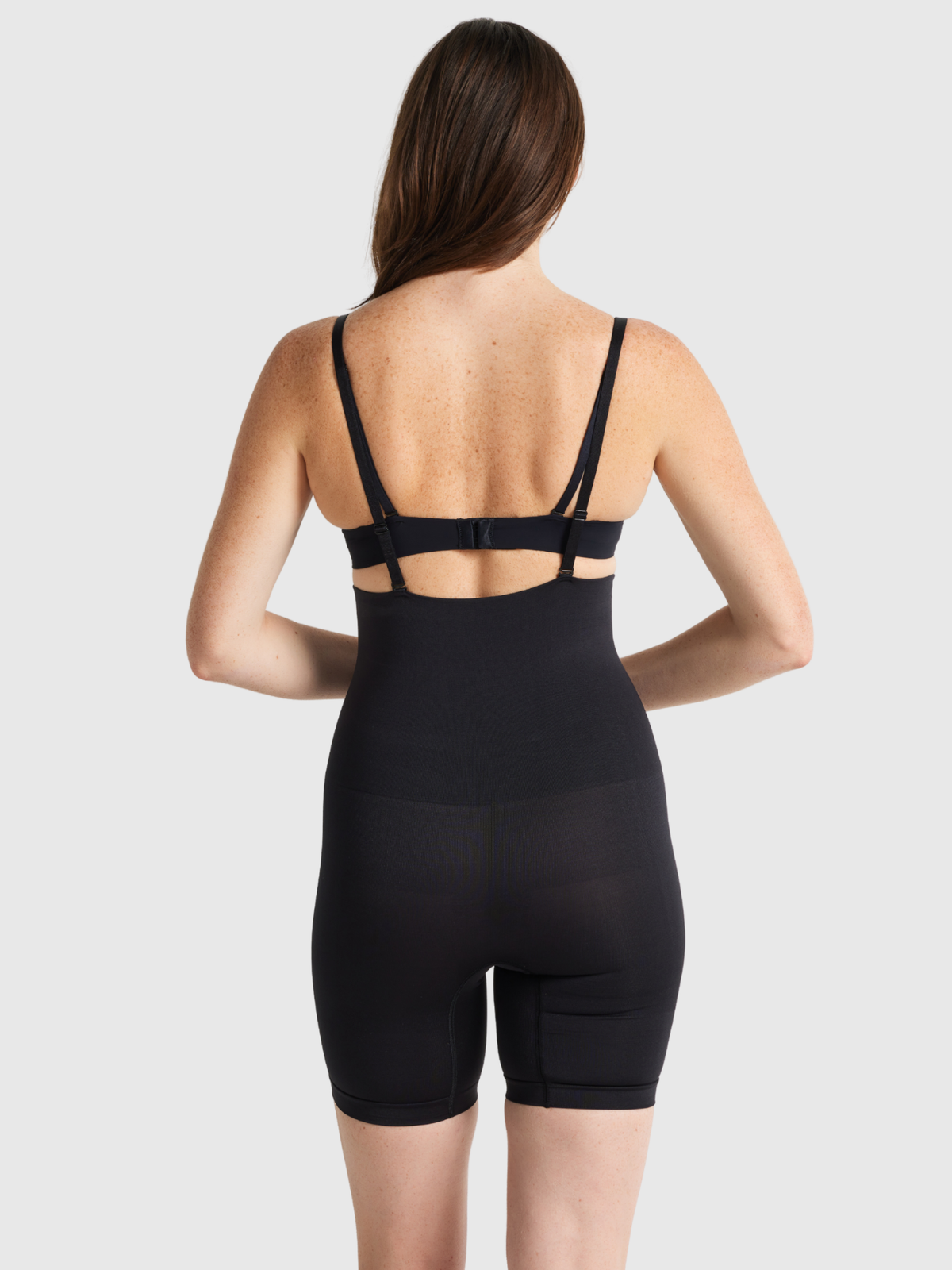 Nancy Ganz Seamless Seduction high waisted thigh shaper in Black, back view showing support straps and seamless back