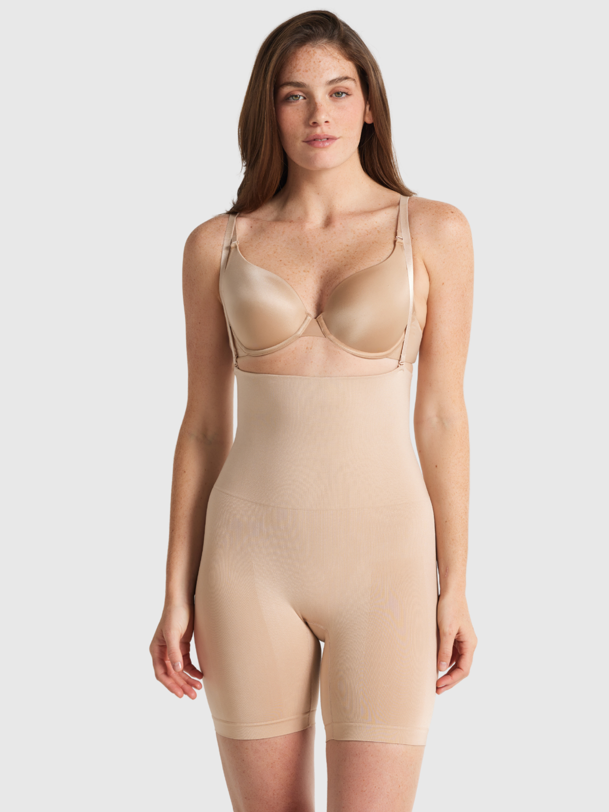Nancy Ganz Seamless Seduction high waisted thigh shaper in Warm Taupe, front view with support straps over the shoulders