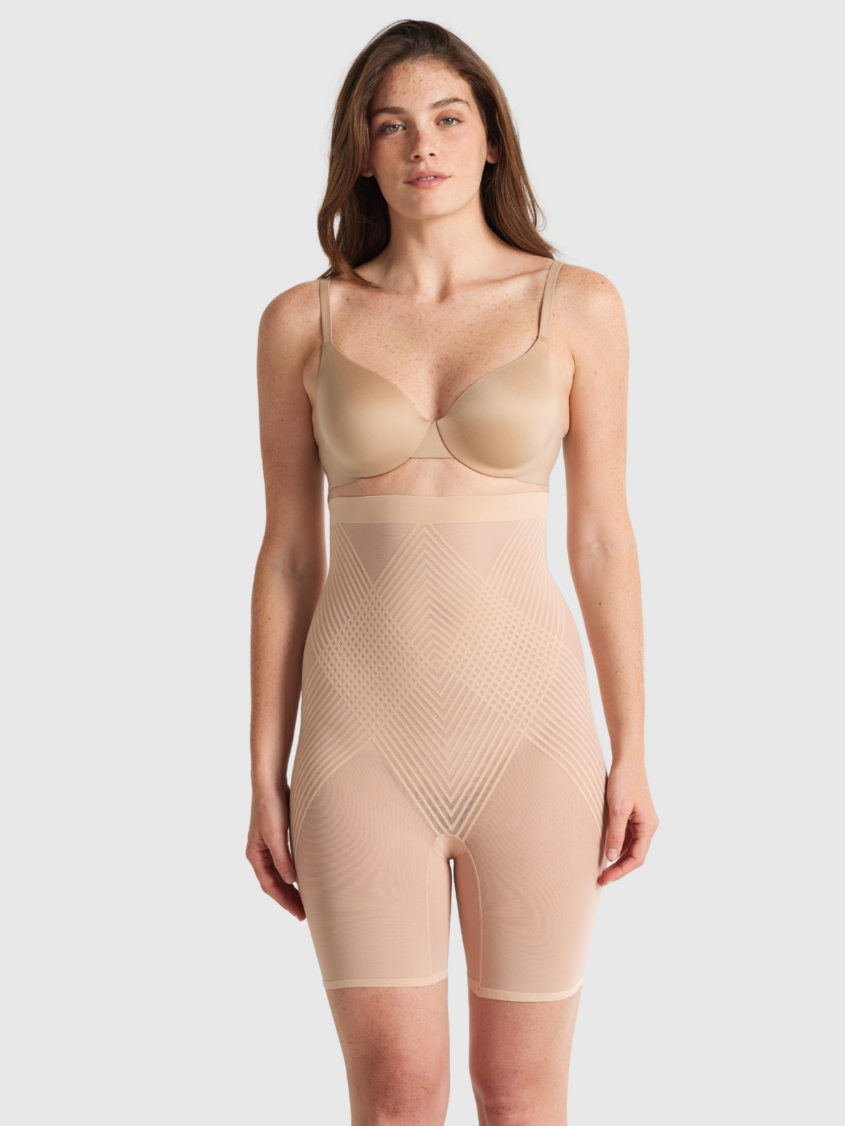 Nancy Ganz Sheer Power High Waisted Thigh Shaper in warm taupe, side view showing high rise coverage and firm shaping down the thigh